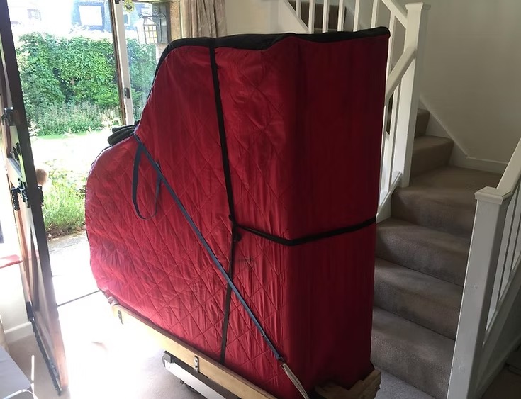 Piano removals professional moving red covered piano storage